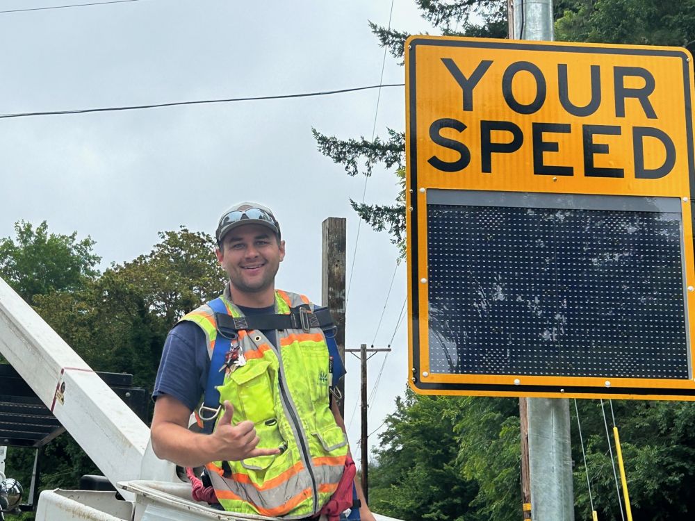 Photo of Joel Zeni on OR 126 installing the speed feedback signs