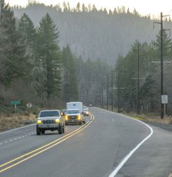 photo of traffic on OR 6 and a street name sign reading "Fox Creek Ridge Road"