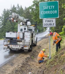 photo of ODOT maintenance installing safety corridor signs