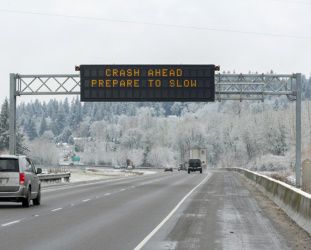 photo of a variable message sign saying crash ahead prepare to slow