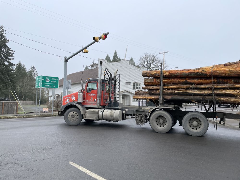 Photo showing a log truck turning on OR 226.