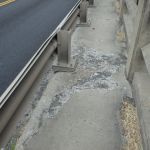 Damaged concrete sidewalk.}